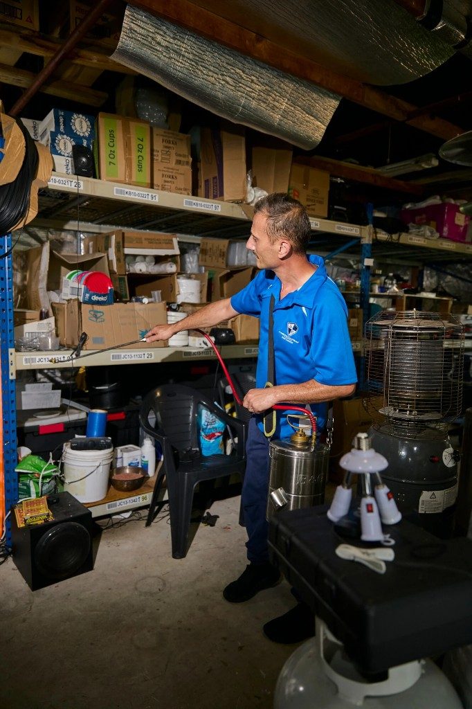 Commercial cockroach pest control technician treating storage in a Sydney business