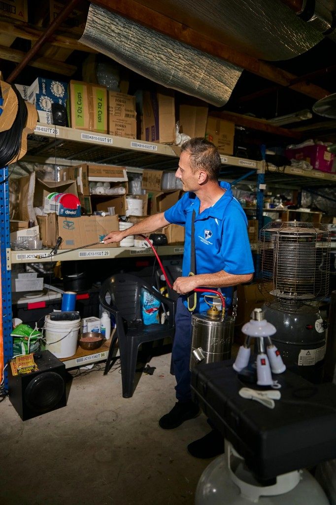 Commercial pest control technician treating storage in a Sydney business